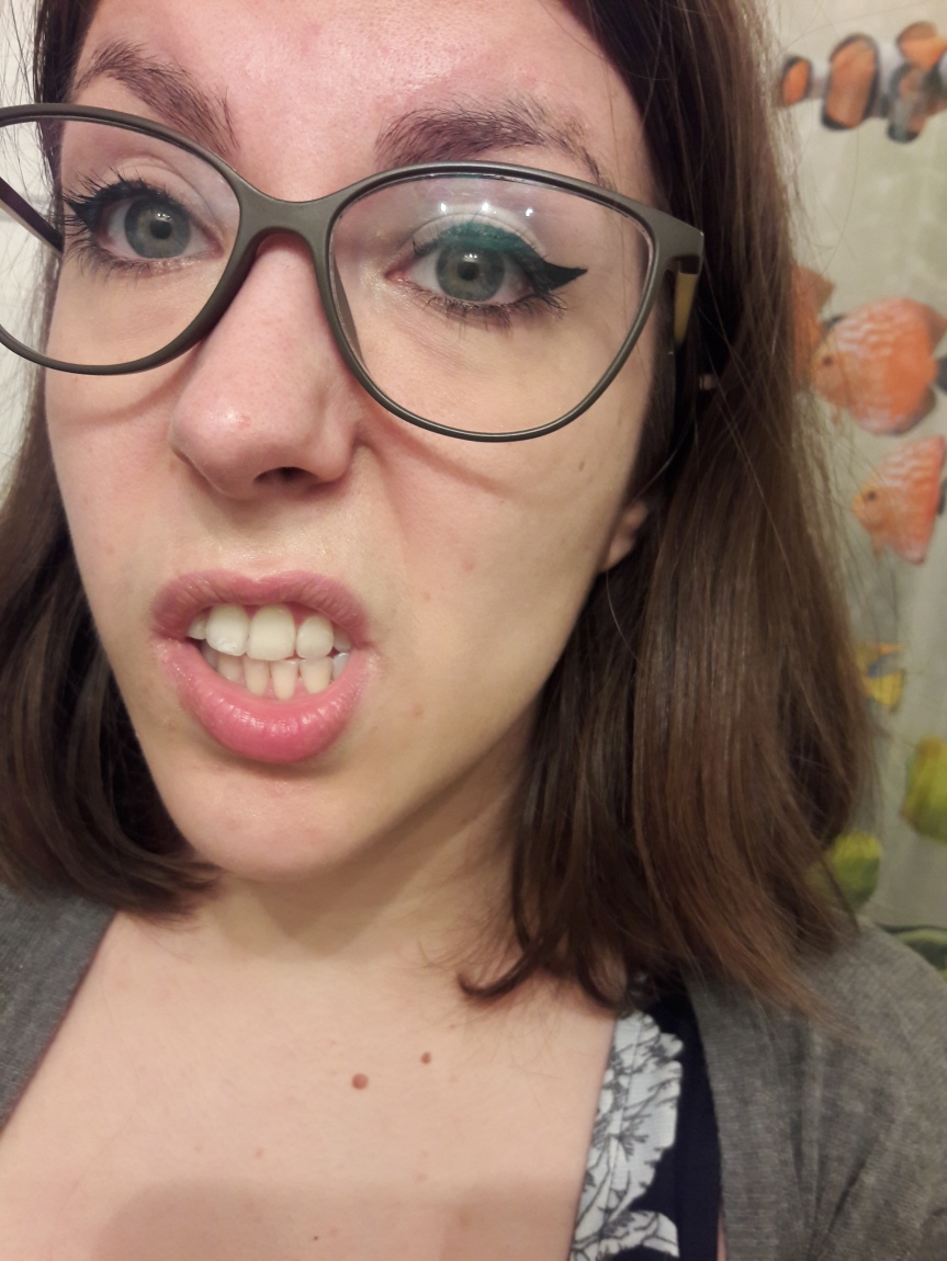 A moderately unflattering picture of me wearing this month's ipsy products. The only thing you can tell I've got on is black winged eyeliner.