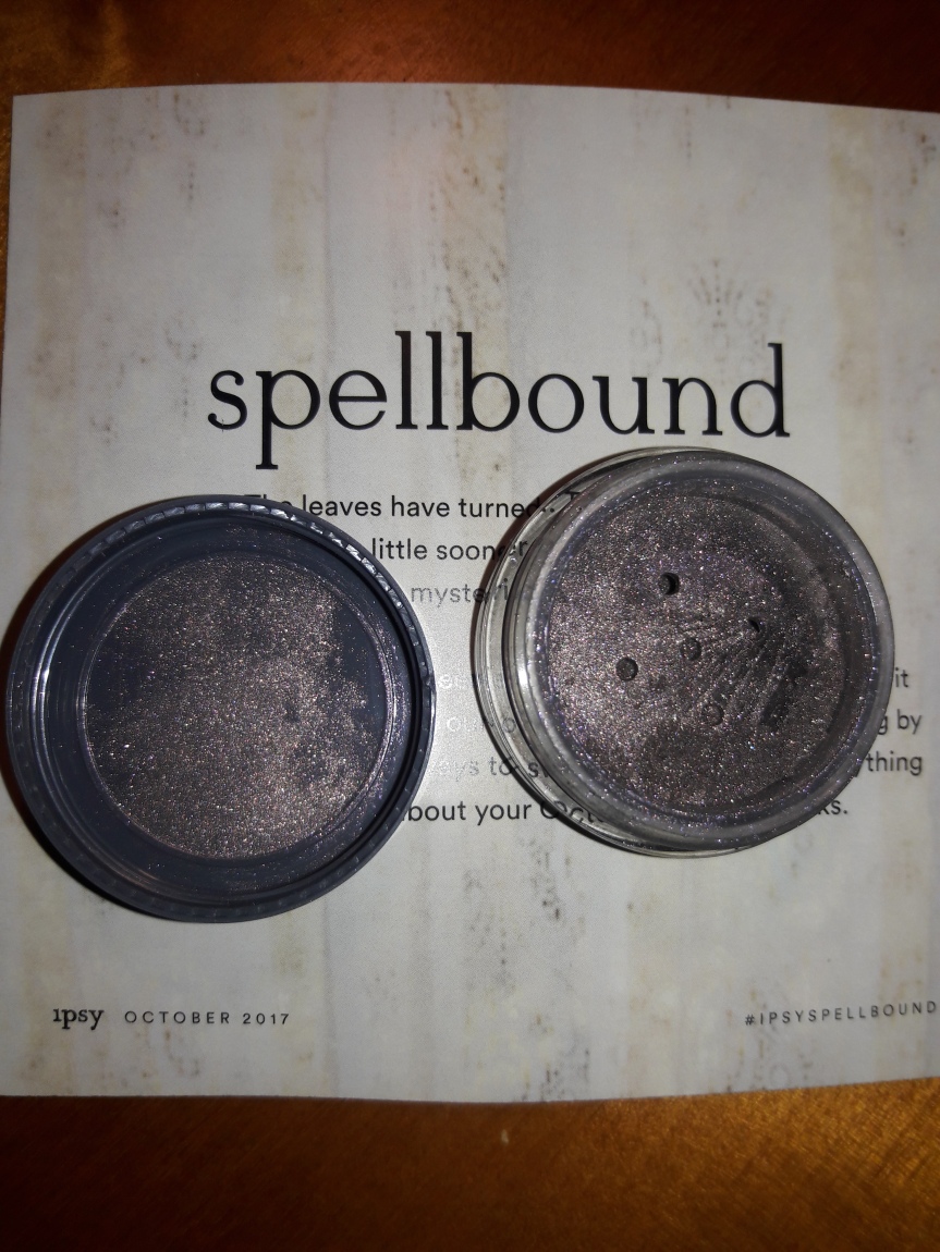 MEECH AND MIA Loose Eyeshadow in Purple. The jar is open, so you can see what a mess it makes on the lid. There are five holes that let the shadow up into the application area.