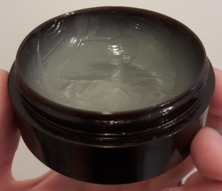 Image of the Aritaum Ginger Sugar Overnight Lip Mask. It looks a lot like Vaseline. This is a side view, showing that I've used quite a bit of the product.