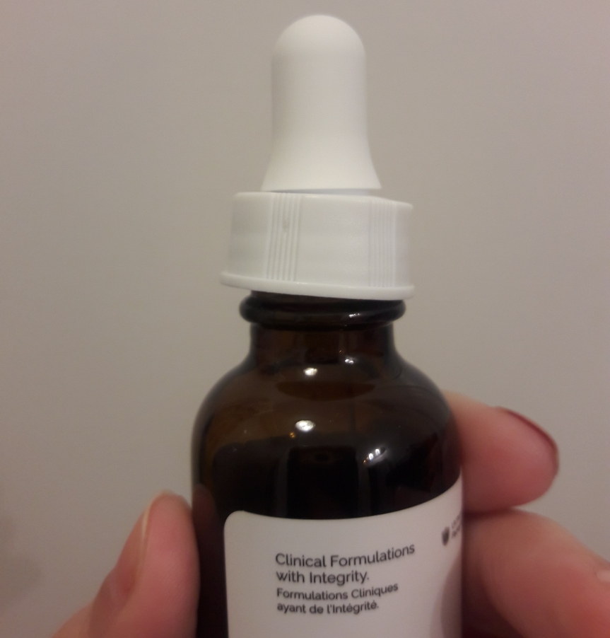 Image of The Ordinary's Caffeine Solution bottle. The threading is jacked up so it doesn't completely close.